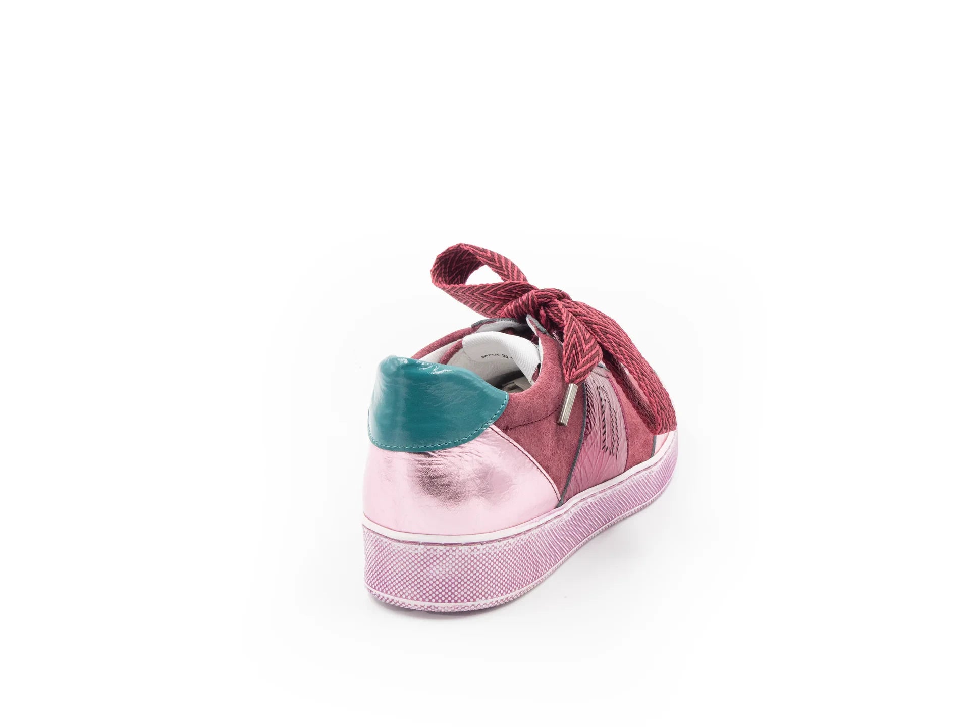 A pink sneaker with a lace-up closure, featuring a low heel and a round toe shape.