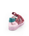 A pink sneaker with a lace-up closure, featuring a low heel and a round toe shape.