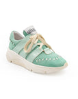 A green sneaker with lace-up closure, featuring a removable insole and reinforced arch.