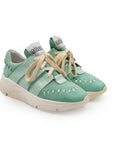A green sneaker with lace-up closure, featuring a removable insole and reinforced arch.