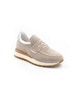 A beige sneaker with a Velcro strap and a low heel, suitable for casual wear.