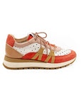A women's sneaker with a beige, red, and white color scheme, featuring a lace-up closure and a flat sole.