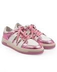 Pink and white sneakers with lace-up closure, featuring a low-top design and a flat sole.