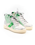 A high-top sneaker with a mix of silver and green colors, featuring a lace-up closure and a flat sole.