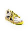 A sneaker with silver upper, yellow laces, and a beige sole.