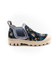 A sneaker with a multicolored floral print, featuring a round toe, a pull tab on the heel, and a flat sole.