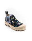 A sneaker with a multicolored floral print, featuring a round toe, a pull tab on the heel, and a flat sole.