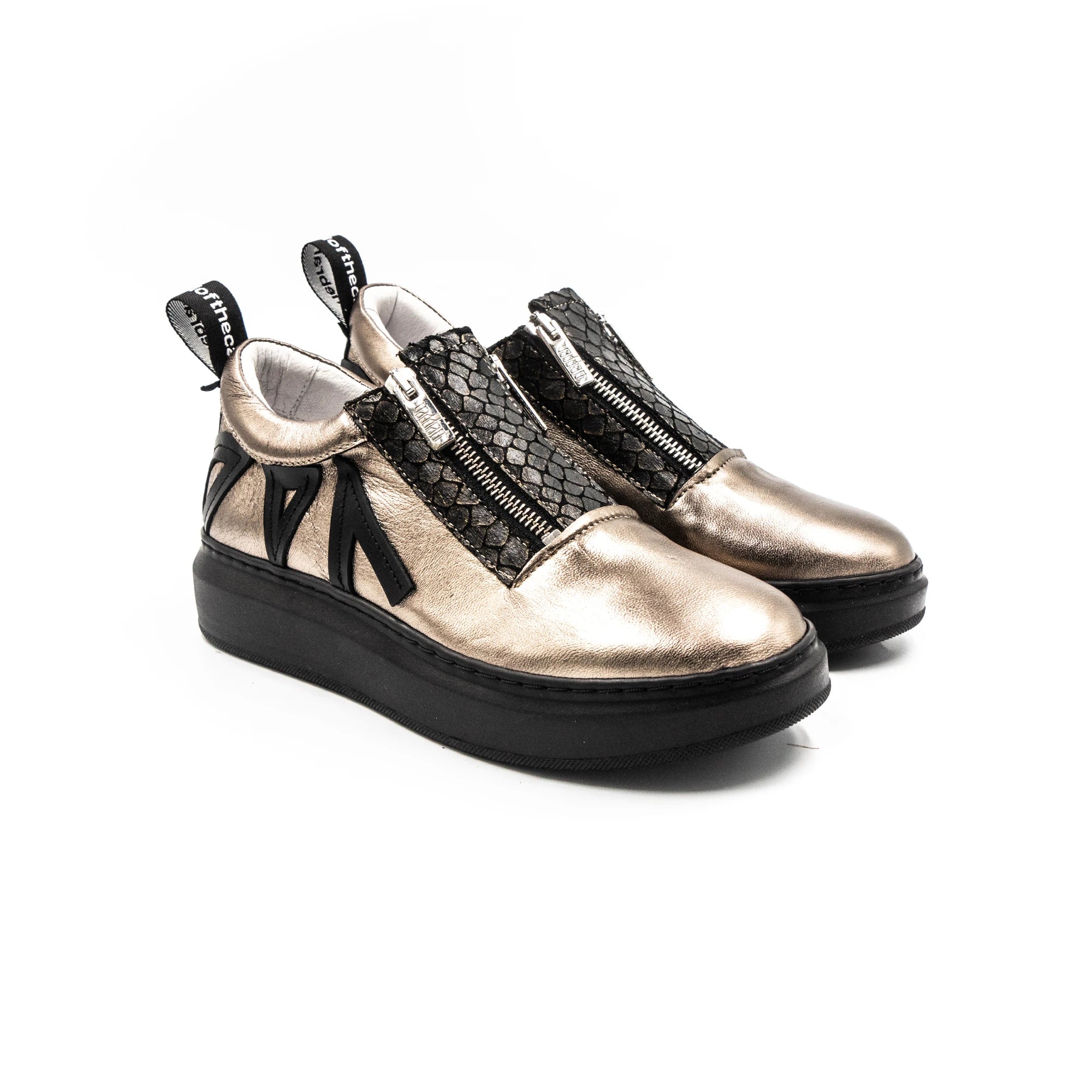 Brass sneakers with zippers.