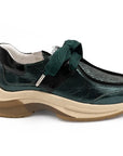Green shoe with a brown sole on a white background