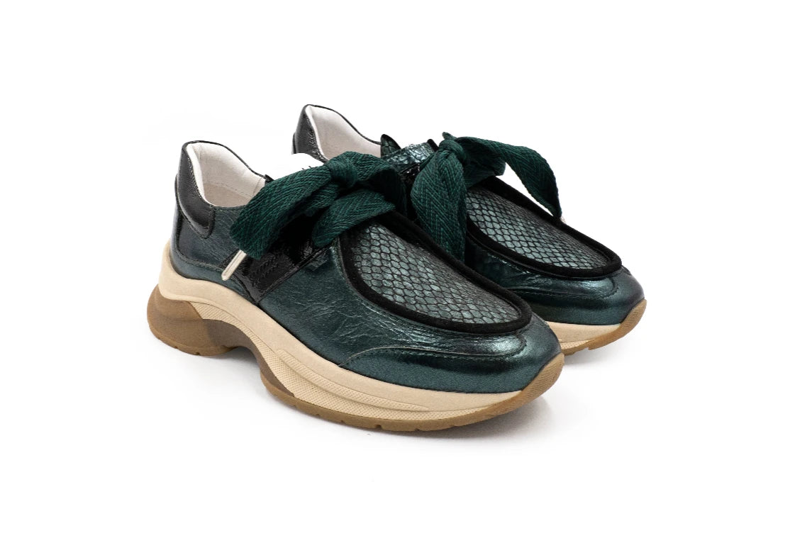 Pair of green shoes with white soles on a white background