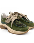 Green suede shoes with leopard print and beige laces on a white background