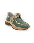 A green sneaker with beige accents and a brown sole, featuring a lace-up closure and a logo on the side.