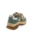 A green sneaker with beige accents and a brown sole, featuring a lace-up closure and a logo on the side.