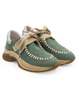 A green sneaker with beige accents and a brown sole, featuring a lace-up closure and a logo on the side.