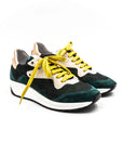 Green sneakers with yellow laces.