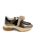 Gold and black sneaker with a thick sole on a white background