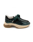 Green shoe with a thick sole on a white background