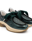 Pair of green shoes with white soles on a white background
