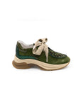 Green sneaker with leopard print accents on a white background