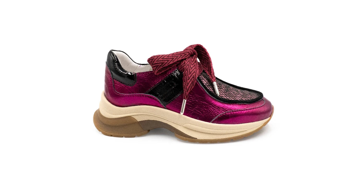 Pink sneaker with black accents on a white background