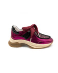 Pink sneaker with a brown sole on a white background